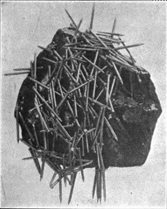 Public domain image of a [lodestone attracting nails](https://commons.wikimedia.org/wiki/File:Lodestone_attracting_nails.png)